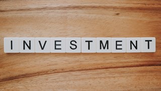 Investment spelt out on a table