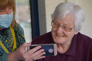 Elderly lady looking at mobile phone 