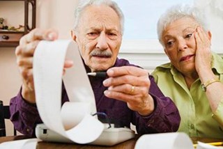 elderly couple looking at finances