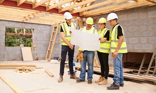 group of builders looking at plans