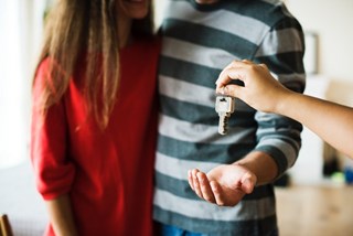 couple getting key to home