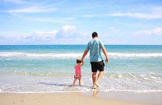 man and child at the beach