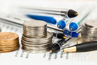 close up of pens and coins