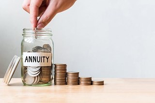 annuity savings jar with stack of coins