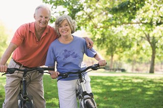 elderly couple on bikes