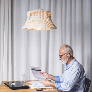 man sat with paperwork at a home desk