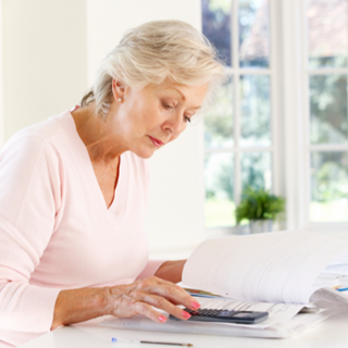 Woman looking at paperwork and doing calculations