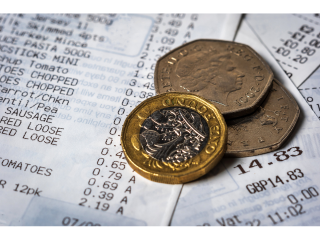 Pound coin and shopping bill
